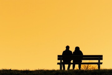 Two silhouettes sitting on a bench against a warm, orange sunset backdrop.