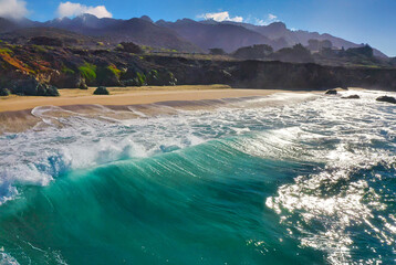 Beach sand sea water summer background. Sand beach desert texture. White foam wave sandy seashore top view.