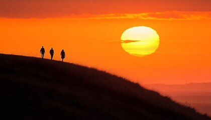 Silhouettes of Three People Enjoying the View of Golden Sunset Over a Hillside with Text Space.