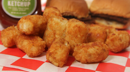 Tater Tots With Mini Hamburgers and Ketchup on Table