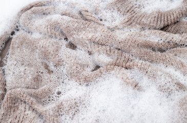 Close up of Light Colored Fine Merino Wool Sweater being Soaked in Delicate Wash 