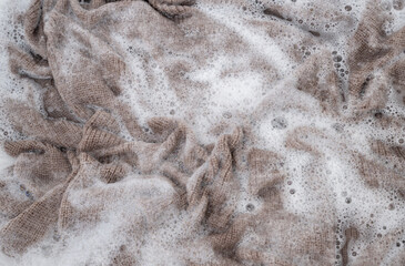 Close up of Light Colored Fine Merino Wool Sweater being Soaked in Delicate Wash 