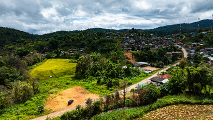 Aerial view of The entrance to Pang Ung Dam has rice terraces along the way, which looks beautiful and blends in with nature. Wat Baan Hai Makhuea Som is a temple and center of the local people.