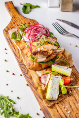 Bruschetta with chicken, radish, microgreens and red onion on wooden board