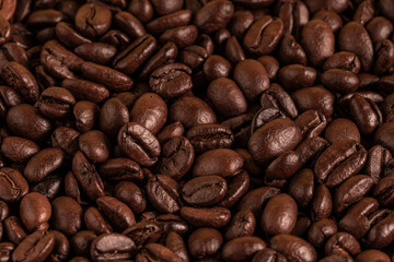 Aromatic Roasted Coffee Beans Textured Background. Close-up of roasted coffee beans forming a textured background. Perfect for concepts related to coffee production, brewing, café culture