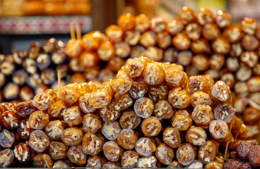 The Lokum, with its signature translucent appearance and embedded walnuts, is arranged in colorful piles,