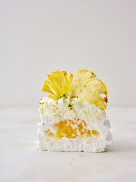 Delicious Modern Cake Slice With Pineapple and Cream Highlighting Tropical Flavors in a Minimal Setting