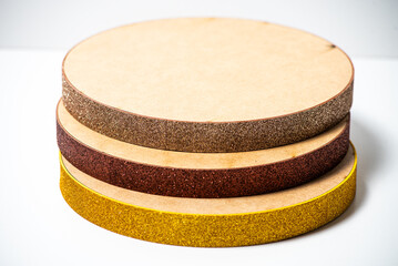 Assorted cake drum bases stacked neatly on a clean white background