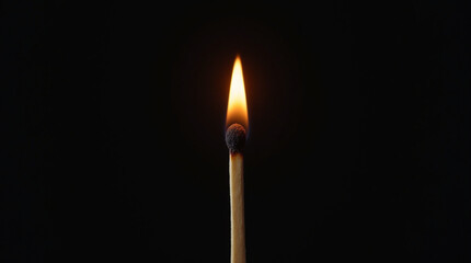 Burning match on black background