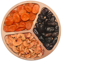 Dried fruit selection on a wooden platter showcasing various textures and colors in a simple arrangement