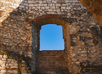 fragment of the ruins of a medieval castle with elements of the walls and a window