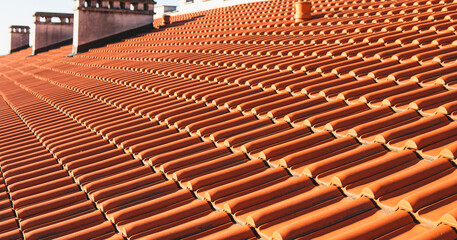 close-up of a roof built with orange-colored ceramic tiles
