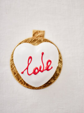 Decorative Cookie With Love Design on a Simple Background Showcases Modern Culinary Artistry