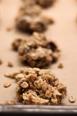 The process of preparing homemade oatmeal cookies - raw, formed cookies placed on a baking tray lined with baking paper
