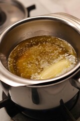 The process of preparing homemade oatmeal cookies - butter and honey melted in a metal bowl