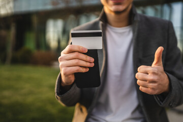 adult man use mobile phone and credit card for online shopping outdoor