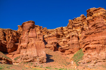 Fototapeta premium Charyn Canyon, Valley of Castles. The excellence of Kazakhstan. Panorama of natural unusual landscape. The red canyon of extraordinary beauty looks like a Martian landscape.