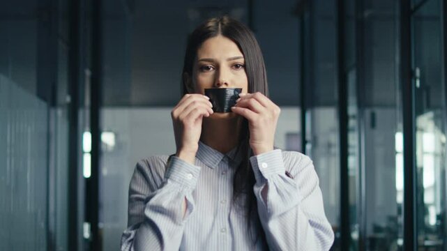 Woman in a professional outfit applies black duct tape over her mouth in an office environment, expressing themes of silence and oppression. Concept of censorship and freedom of speech