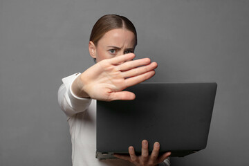 covering face with hand and putting other hand up front to stop camera, refusing photos or pictures