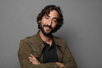 smiling to camera with crossed arms and a happy, confident, satisfied expression, lateral view