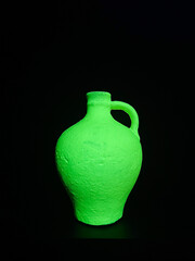 Bright green fluorescent jug on a dark background. Perfect for modern art projects, futuristic themes, or promotional visuals.