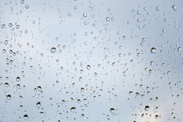 grey moody raindrops on a window glass