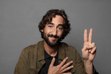 looking happy, confident and trustworthy, smiling and showing victory sign, with a positive attitude