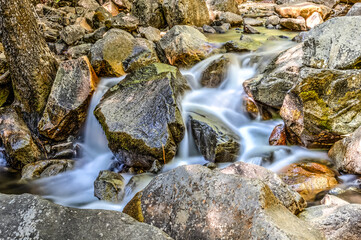 A stream of water flows over a rocky riverbed