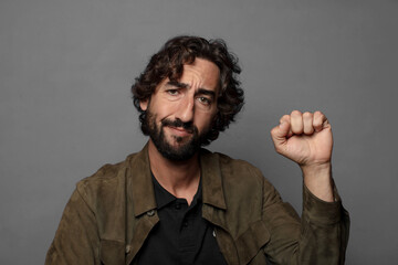 feeling serious, strong and rebellious, raising fist up, protesting or fighting for revolution