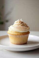 Delightful cupcake topped with creamy frosting sits elegantly on