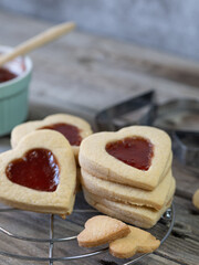 Closeup of a stack of heart shaped cookies with strawberry jam. Special Valentine's Day candy