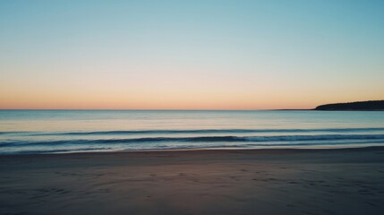 Serene sunset over calm ocean beach.