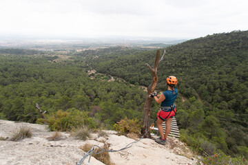 Obraz premium Femme en via ferrata en Espagne escalade rocher casque