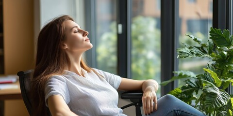 A young woman sits peacefully chair, basking in sunlight streaming through large windows, embodying relaxation, introspection, and a moment of calm amidst daily life.