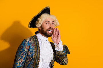 Smiling man with royal antique attire posing against a vibrant yellow backdrop