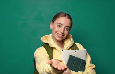 smiling happily with friendly, confident, positive look, offering and showing an object or concept