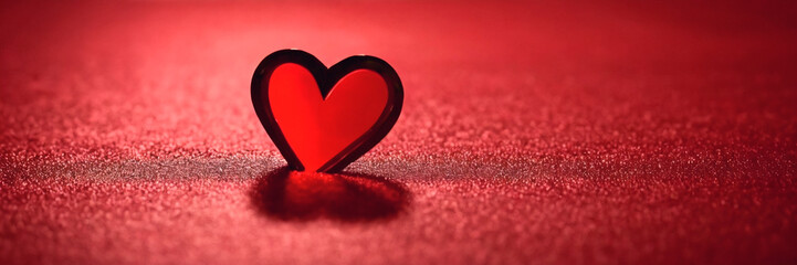 Fototapeta premium Heart Shaped Decoration on a Red Surface Symbolizes Love and Affection in a Vibrant Setting
