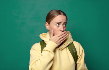 covering mouth with hands with a shocked, surprised expression, keeping a secret or saying oops