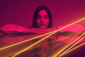 High Fashion model woman in colorful bright neon blue and purple lights posing in studio. Portrait of beautiful woman with trendy glowing make-up. Art design vivid style