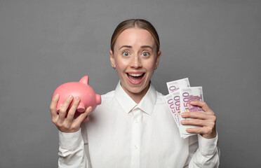 pretty blonde woman with a piggy bank