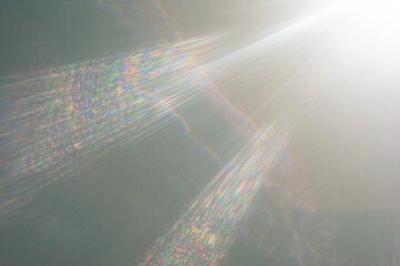 Bright sunlight beams creating iridescent lens flare.