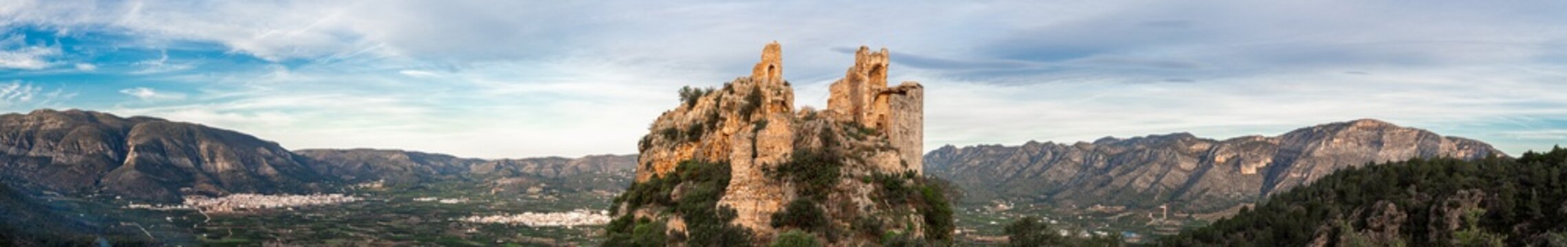 Panoramic view, landscape with mountains and the ruins of a castle in the hill, Marinyen Castle, in Benifair&oacute; de la Valldigna, Valencia (Spain).