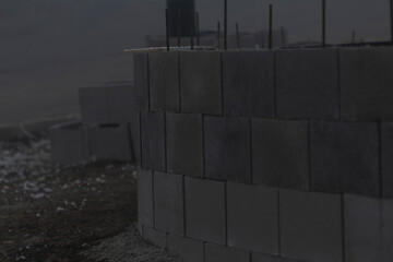 An active construction site showcasing an arrangement of stacked stone blocks alongside numerous...