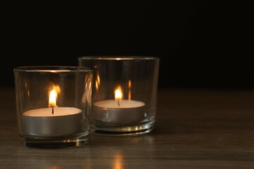 Burning candles in a dark space