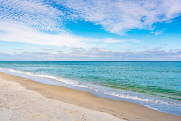 beach and ocean with clouds in blue sky