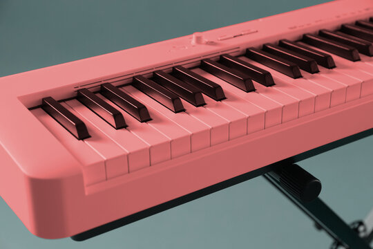 Pink synthesizer on grey background, closeup. Electronic musical instrument - Powered by Adobe
