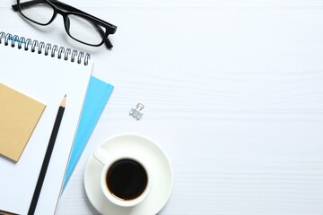 Workplace with notebook, pencil, glasses, cup of coffee, top view 