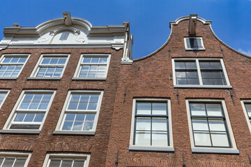 Dutch architecture. Pair of typical Dutch houses against a blue sky in Amsterdam. Netherlands. Horizontally.