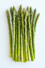 Bunch of green asparagus are arranged in a row. The asparagus are fresh and vibrant, with a bright green color. Concept of health and vitality, as the asparagus are a nutritious