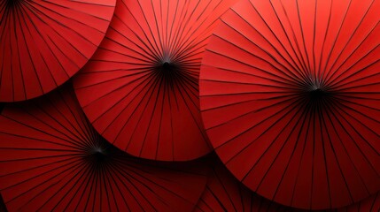 Close-up of several vibrant red paper parasols overlapping, creating a textured pattern.